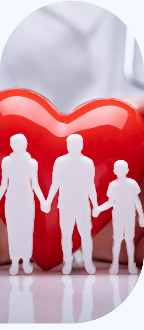 A paper family standing in front of a red heart