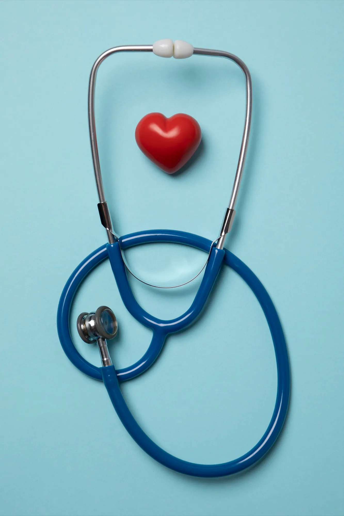 A stethoscope and a red heart on a blue background
